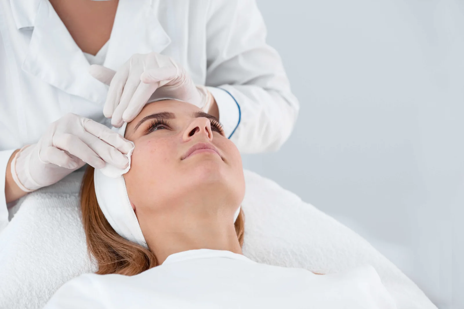 Practitioner assessing a patient's forehead before wrinkle treatment